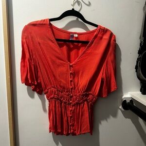Red Peplum like top, great to wear with jeans for a casual outfit!